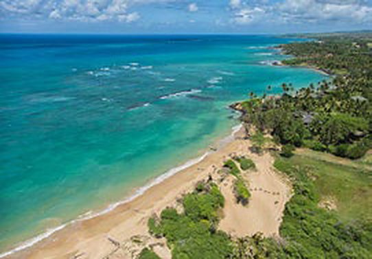 Aerial view of a turquoise reef and sandy shoreline